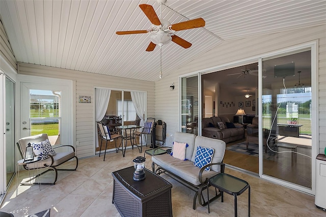 sunroom / solarium with ceiling fan, wood ceiling, and vaulted ceiling