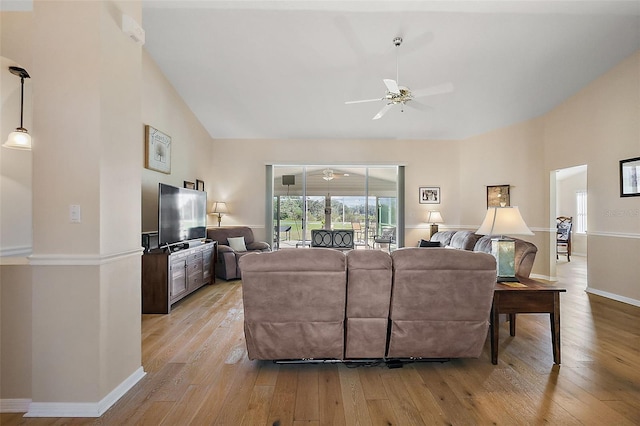 living room with ceiling fan, light hardwood / wood-style floors, and high vaulted ceiling