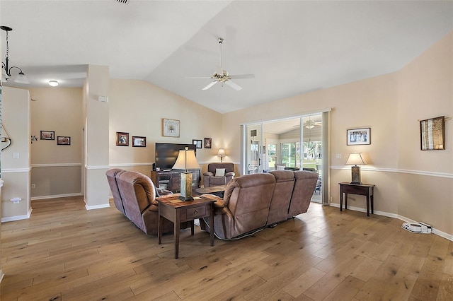 living room with ceiling fan, light hardwood / wood-style flooring, and lofted ceiling