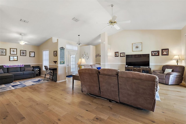 living room with ceiling fan, light hardwood / wood-style floors, and lofted ceiling