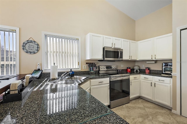 kitchen with white cabinetry, sink, high vaulted ceiling, and stainless steel appliances