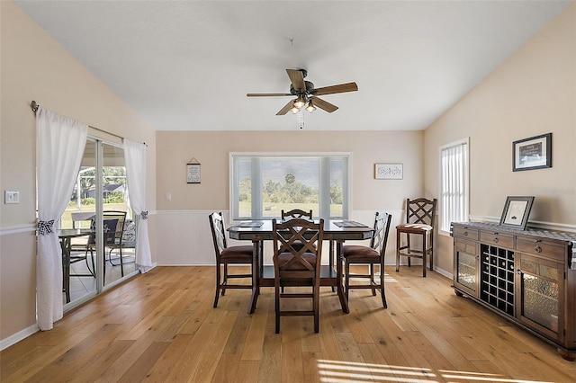 dining space with ceiling fan, light hardwood / wood-style floors, and lofted ceiling