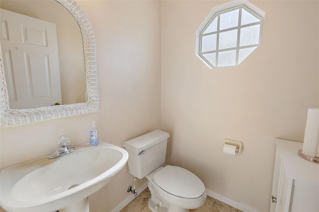 bathroom featuring tile patterned floors, sink, and toilet