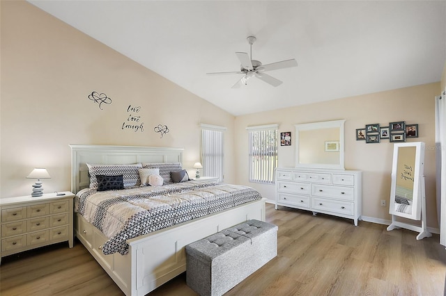 bedroom featuring light wood-type flooring, vaulted ceiling, and ceiling fan