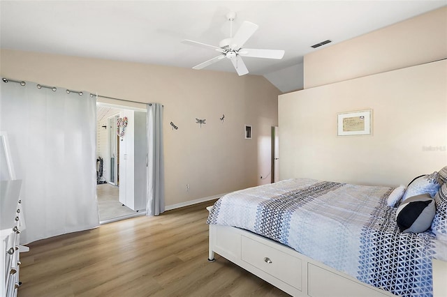 bedroom featuring light hardwood / wood-style flooring, ceiling fan, and lofted ceiling