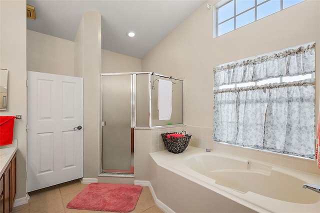 bathroom featuring tile patterned floors, separate shower and tub, vanity, and vaulted ceiling