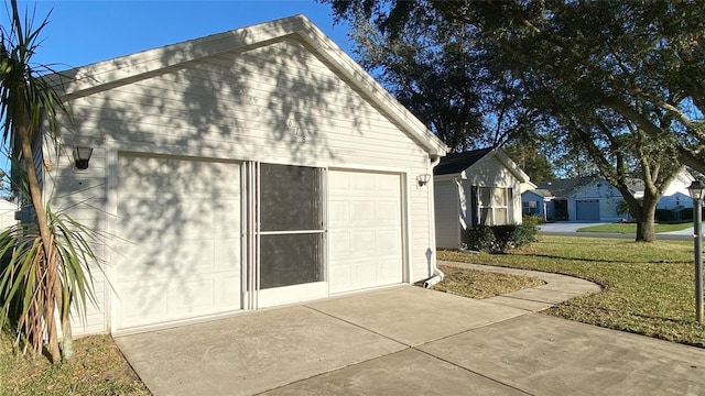 view of side of home with a yard, a garage, and an outdoor structure