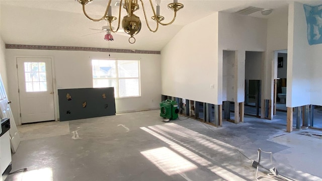 unfurnished living room with a chandelier, concrete floors, and vaulted ceiling