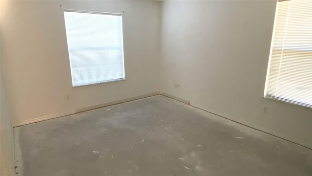 spare room with concrete flooring