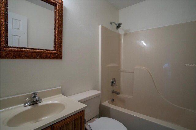 full bathroom with bathing tub / shower combination, vanity, and toilet