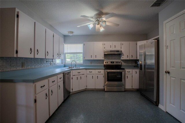 kitchen featuring ceiling fan, white cabinetry, and stainless steel appliances