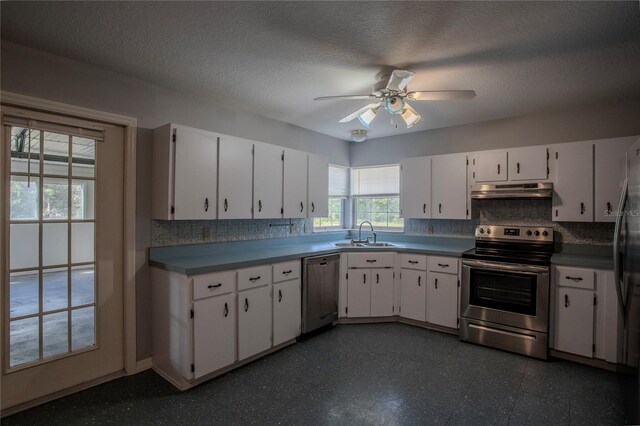 kitchen with ceiling fan, sink, stainless steel appliances, a textured ceiling, and white cabinets