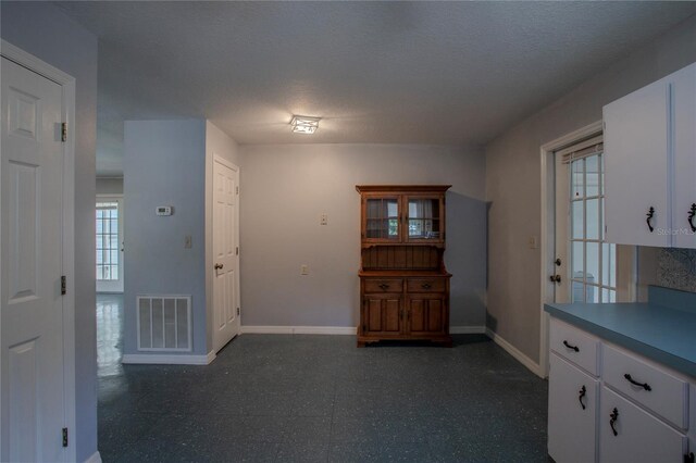 interior space with a textured ceiling