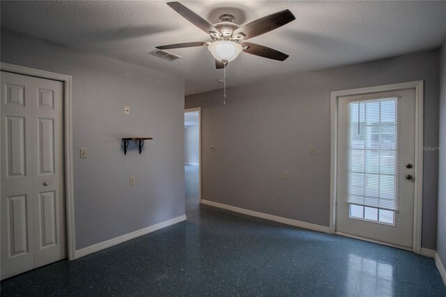 spare room featuring ceiling fan and a textured ceiling