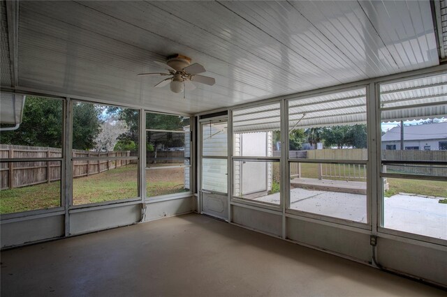 unfurnished sunroom featuring ceiling fan