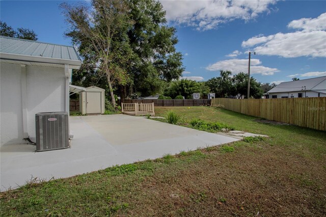 view of yard featuring a patio, a shed, and cooling unit