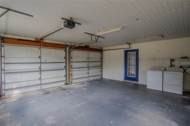 garage featuring washer and dryer and a garage door opener