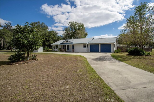 single story home with a garage and a front lawn