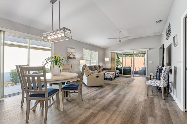 dining area featuring hardwood / wood-style floors, vaulted ceiling, and ceiling fan