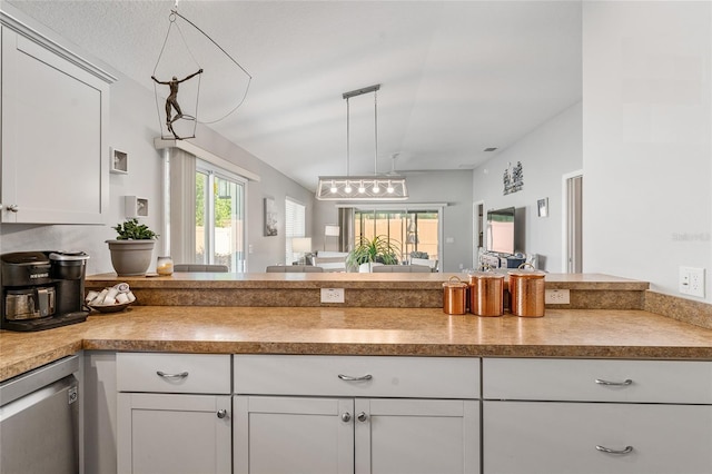 kitchen featuring stainless steel dishwasher, decorative light fixtures, white cabinetry, and kitchen peninsula