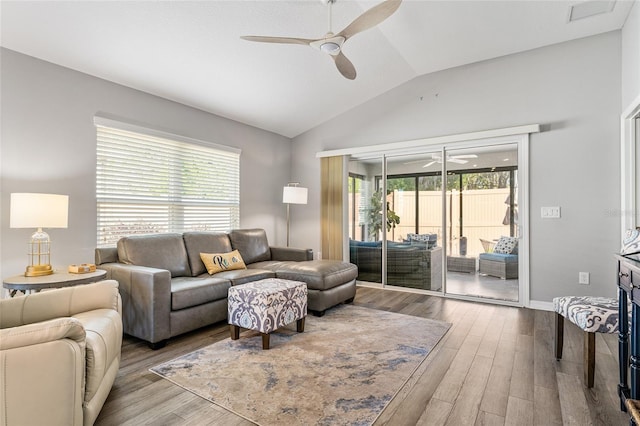 living room with lofted ceiling, ceiling fan, and wood-type flooring