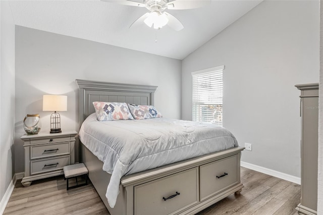 bedroom featuring ceiling fan, vaulted ceiling, and light hardwood / wood-style flooring