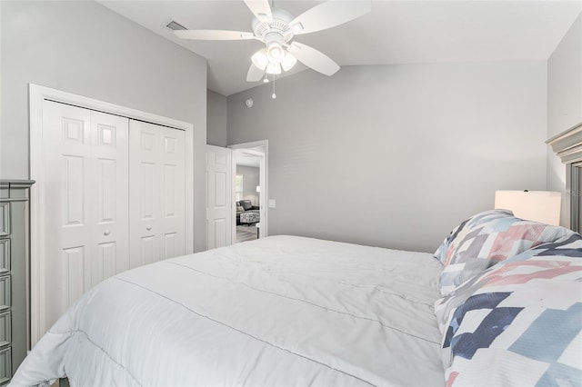 bedroom with ceiling fan, vaulted ceiling, and a closet