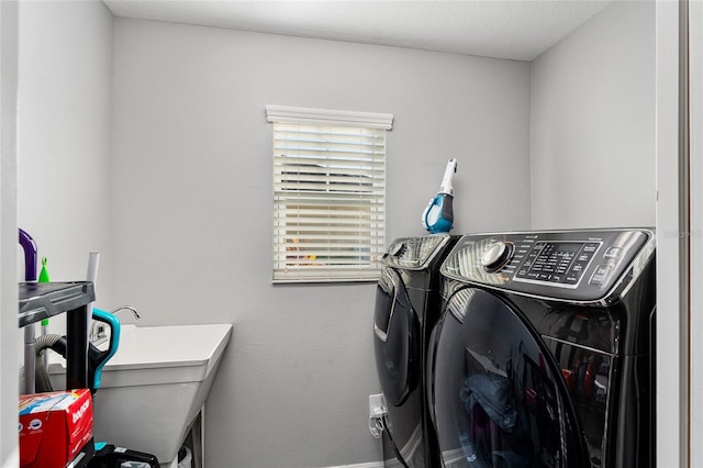 laundry room featuring washing machine and clothes dryer