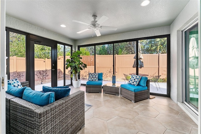 sunroom / solarium featuring ceiling fan and a healthy amount of sunlight