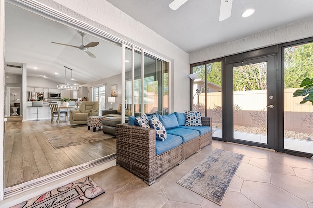 sunroom featuring ceiling fan and vaulted ceiling