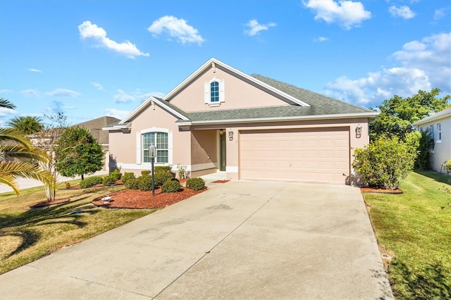 view of front of property with a garage and a front lawn