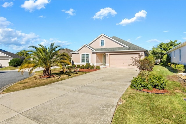 view of front of property featuring a garage and a front lawn