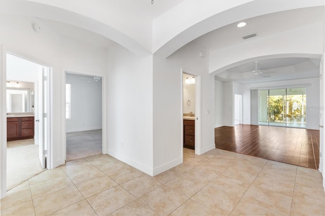 empty room featuring ceiling fan, light hardwood / wood-style floors, and sink