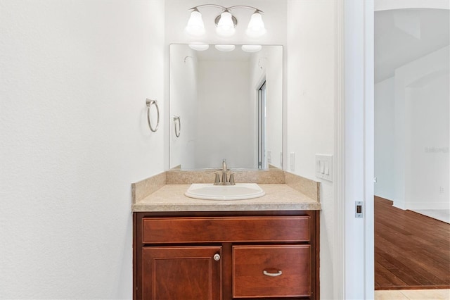 bathroom featuring vanity and wood-type flooring