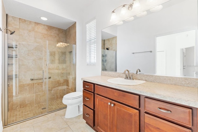 bathroom with tile patterned flooring, vanity, toilet, and a shower with door