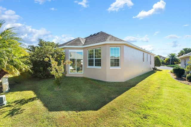 view of side of home featuring a lawn