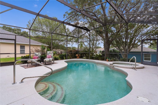 view of pool with an in ground hot tub, a patio, and glass enclosure