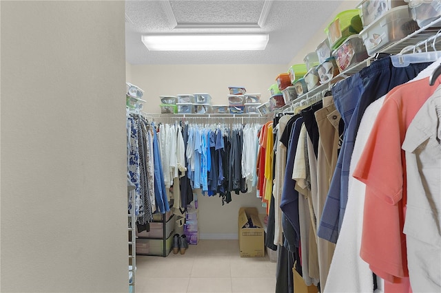 walk in closet with tile patterned flooring