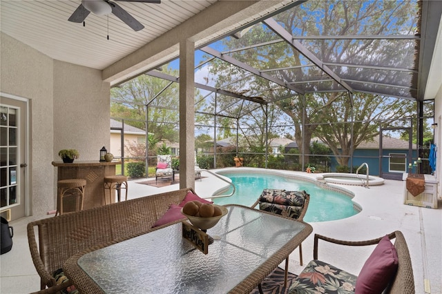 view of pool with an in ground hot tub, a patio, ceiling fan, and a lanai