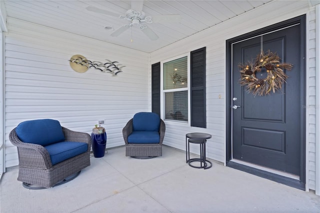 entrance to property featuring ceiling fan and covered porch