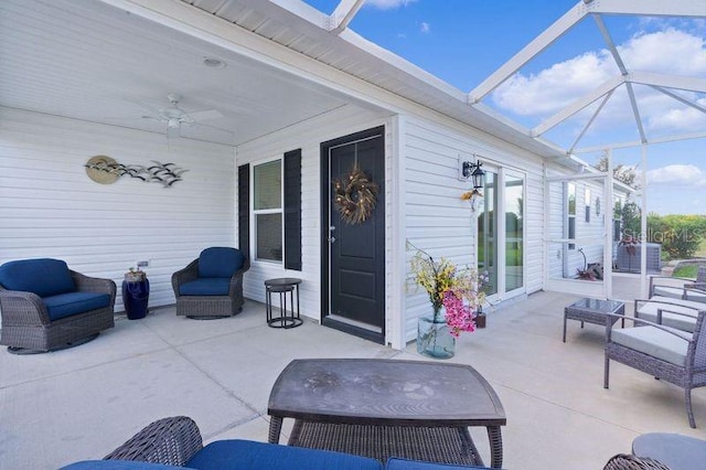 view of patio featuring glass enclosure and ceiling fan