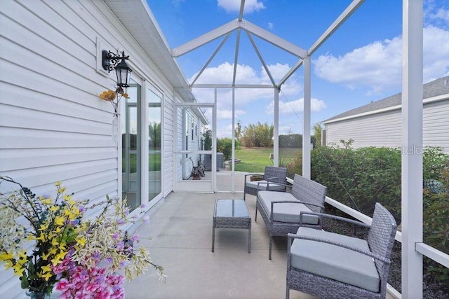 view of patio with glass enclosure