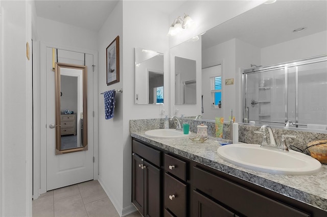 bathroom featuring tile patterned floors, vanity, and an enclosed shower