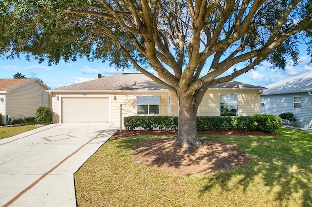 single story home with a front yard and a garage