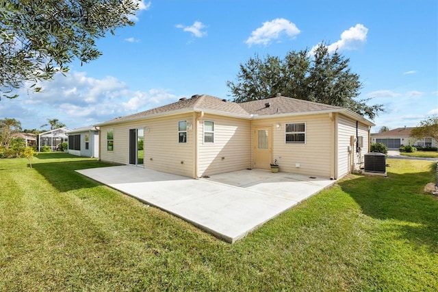 back of property with cooling unit, a patio area, and a lawn