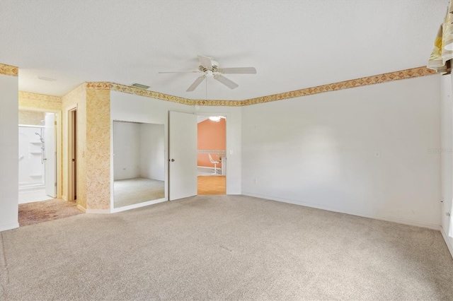 unfurnished bedroom featuring ceiling fan, light colored carpet, and a closet