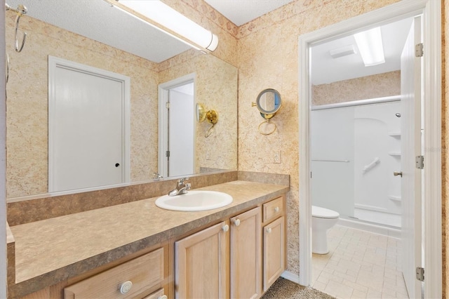 bathroom featuring tile patterned flooring, vanity, toilet, and walk in shower