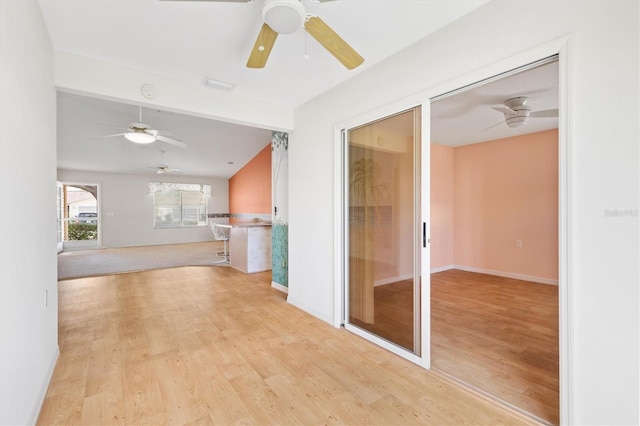 unfurnished living room featuring light hardwood / wood-style floors and lofted ceiling