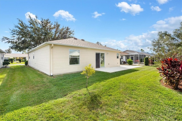 back of house featuring a patio area and a lawn