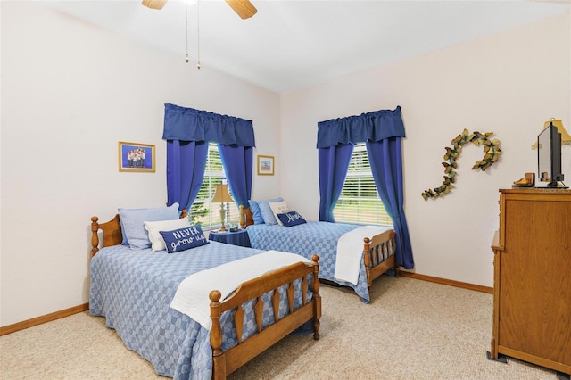 carpeted bedroom with multiple windows and ceiling fan